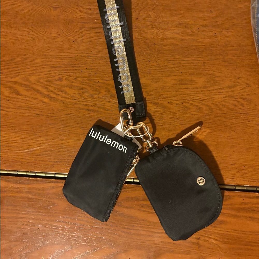 NWT Lululemon dual pouch wristlet black with gold accents